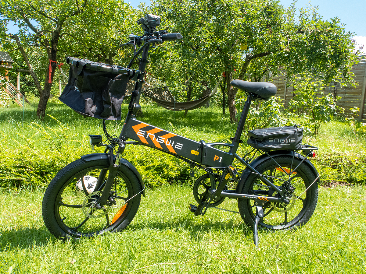 a black bicycle with basket on grass - engwe p1