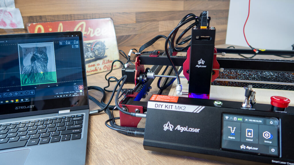 a laptop next to a machine AlgoLaser DIY KIT MK2