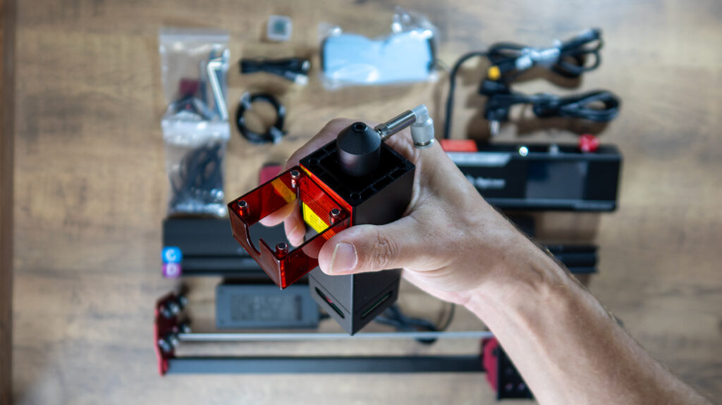 a hand holding a small black box with a red square inside AlgoLaser DIY KIT MK2