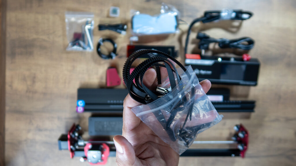 a hand holding a bag of black wires AlgoLaser DIY KIT MK2