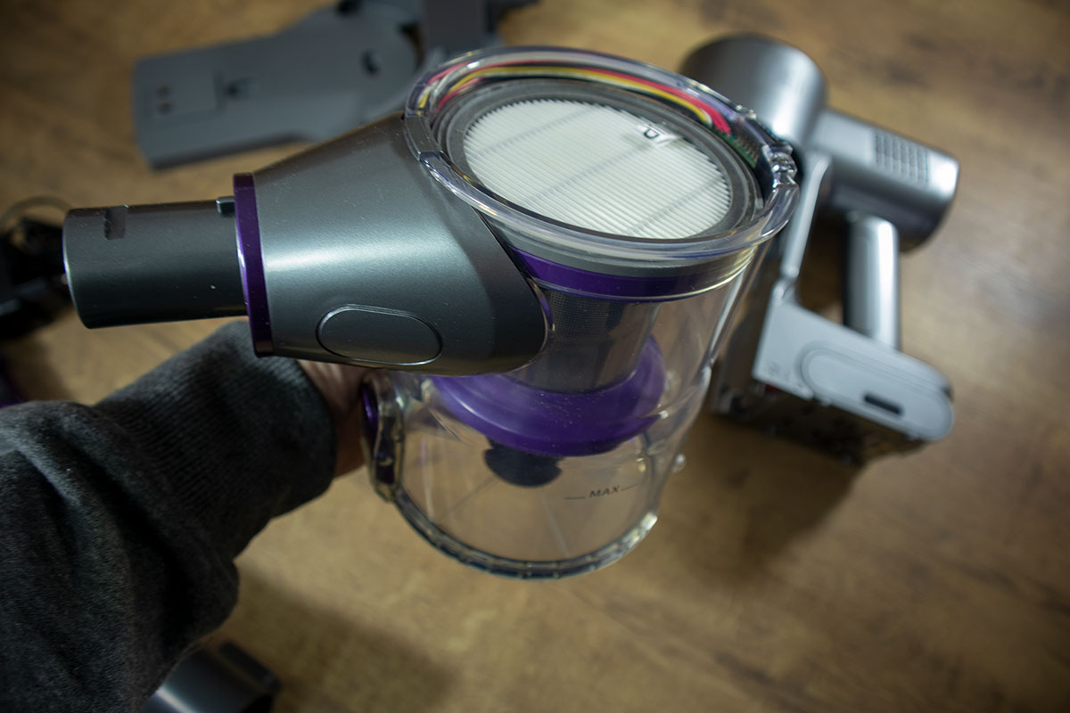 a hand holding a vacuum cleaner dust