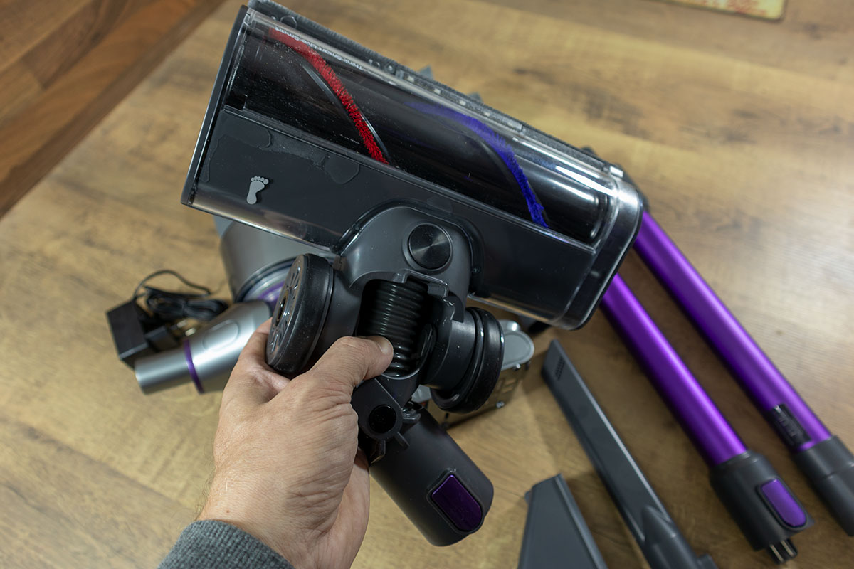 a hand holding a vacuum cleaner head